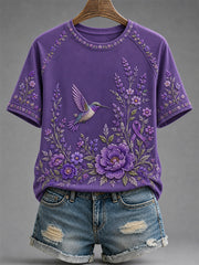 Damen-T-Shirt in Lila mit Blumen- und Kolibri-Print zur Sensibilisierung für die Alzheimer-Krankheit