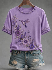 Damen-T-Shirt in Lila mit Blumen- und Kolibri-Print zur Sensibilisierung für die Alzheimer-Krankheit