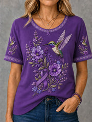 Damen-T-Shirt in Lila mit Blumen- und Kolibri-Print zur Sensibilisierung für die Alzheimer-Krankheit
