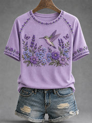 Damen-T-Shirt in Lila mit Blumen- und Kolibri-Print zur Sensibilisierung für die Alzheimer-Krankheit