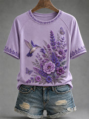 Damen-T-Shirt in Lila mit Blumen- und Kolibri-Print zur Sensibilisierung für die Alzheimer-Krankheit