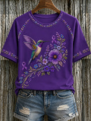 Damen-T-Shirt in Lila mit Blumen- und Kolibri-Print zur Sensibilisierung für die Alzheimer-Krankheit