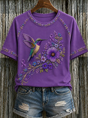 Damen-T-Shirt in Lila mit Blumen- und Kolibri-Print zur Sensibilisierung für die Alzheimer-Krankheit