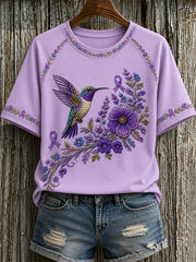 Damen-T-Shirt in Lila mit Blumen- und Kolibri-Print zur Sensibilisierung für die Alzheimer-Krankheit