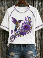 Damen-T-Shirt in Lila mit Blumen- und Kolibri-Print zur Sensibilisierung für die Alzheimer-Krankheit