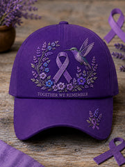 Unisex-Mütze in Lila mit Blumen- und Kolibri‑Muster zur Sensibilisierung für die Alzheimer‑Krankheit