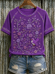 Damen-T-Shirt in Lila mit Blumen- und Kolibri-Print zur Sensibilisierung für die Alzheimer-Krankheit